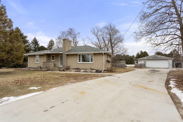 view of front of property featuring a garage and an outdoor structure