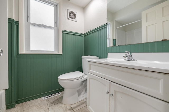 bathroom featuring toilet and vanity