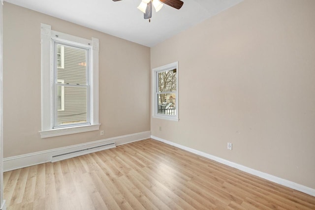 empty room featuring ceiling fan, baseboard heating, and light hardwood / wood-style floors