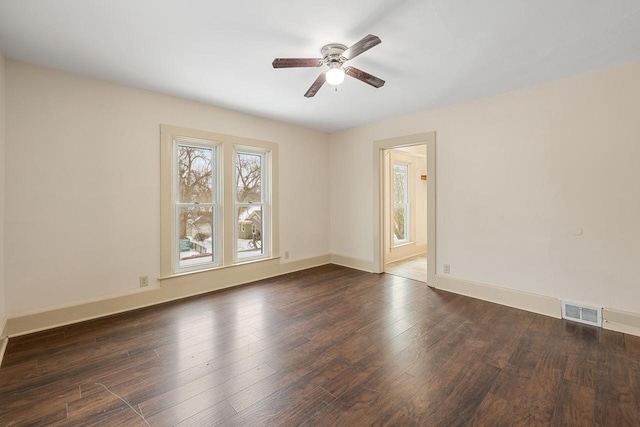 unfurnished room with ceiling fan and dark hardwood / wood-style flooring