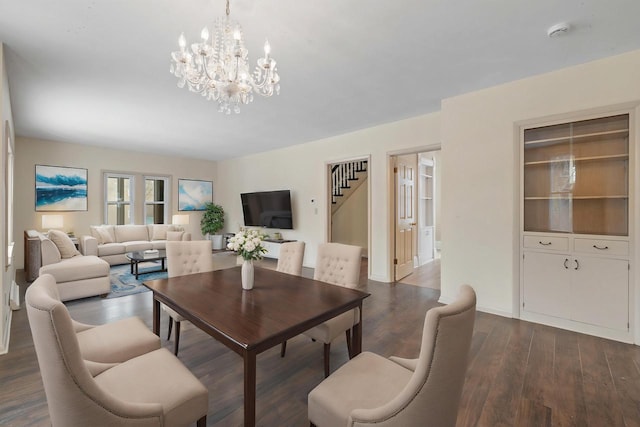 dining space with an inviting chandelier and dark wood-type flooring