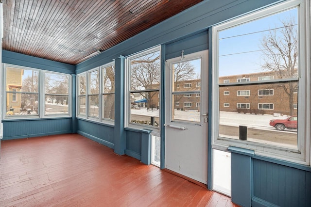 unfurnished sunroom with wooden ceiling and a wealth of natural light