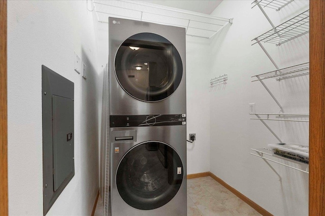 washroom with electric panel and stacked washing maching and dryer