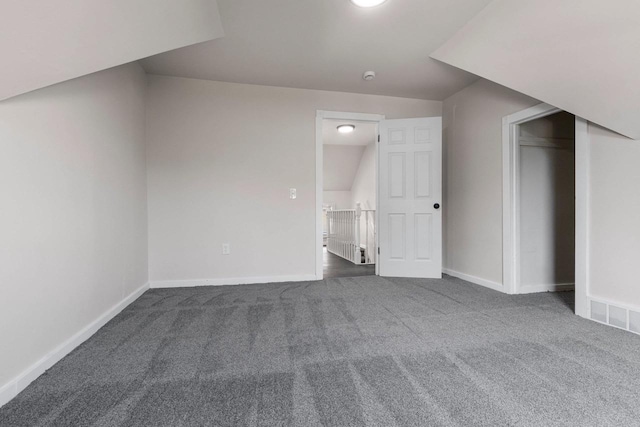 bonus room with dark carpet