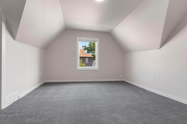 additional living space with lofted ceiling and carpet flooring