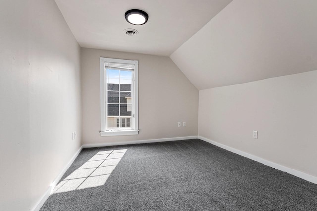 additional living space with carpet floors and vaulted ceiling