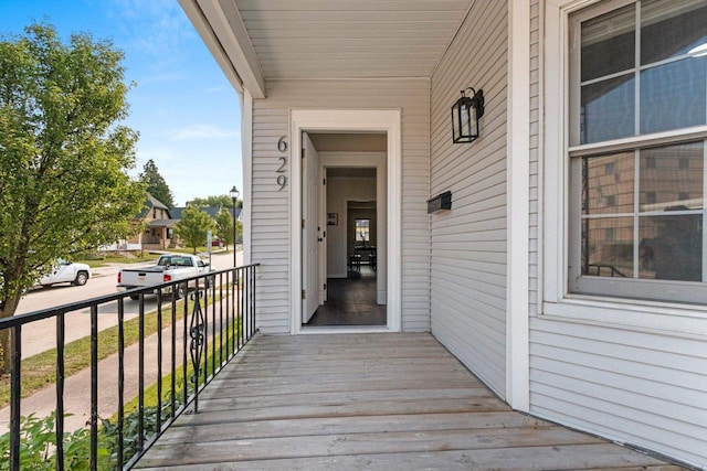 view of exterior entry with a balcony