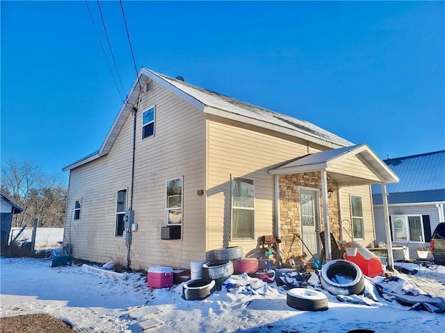 snow covered house featuring an outdoor fire pit