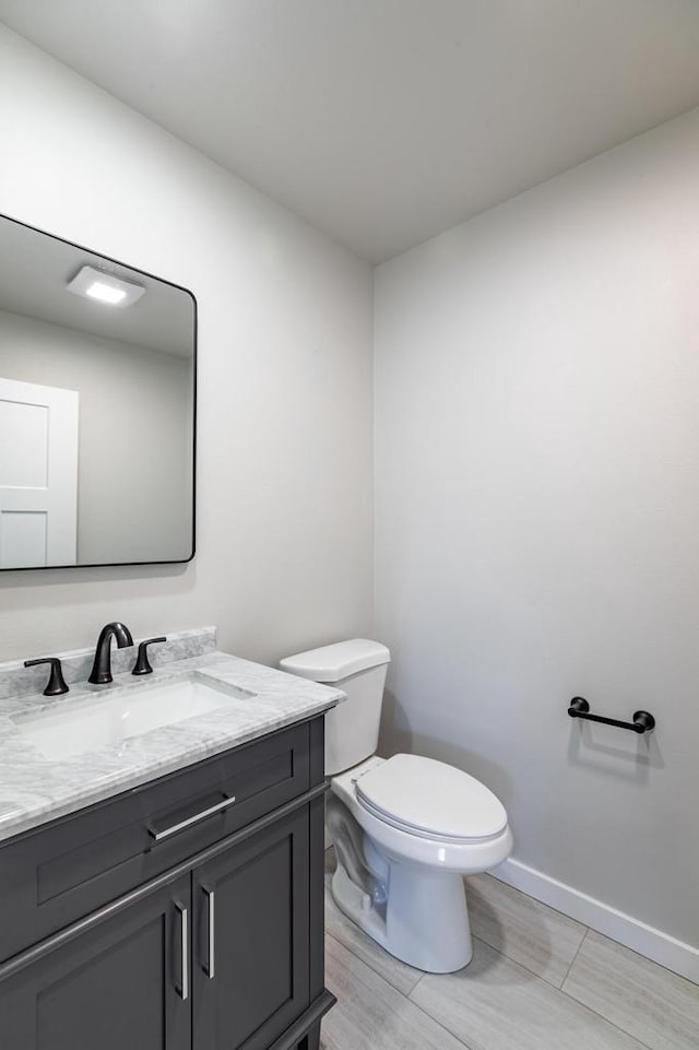 bathroom with toilet and vanity