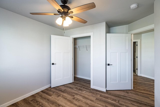 unfurnished bedroom with dark hardwood / wood-style floors, a closet, and ceiling fan