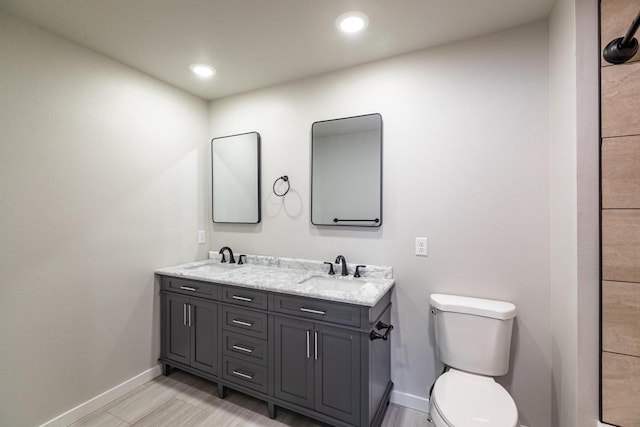 bathroom featuring toilet and vanity