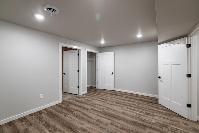 unfurnished bedroom with hardwood / wood-style floors