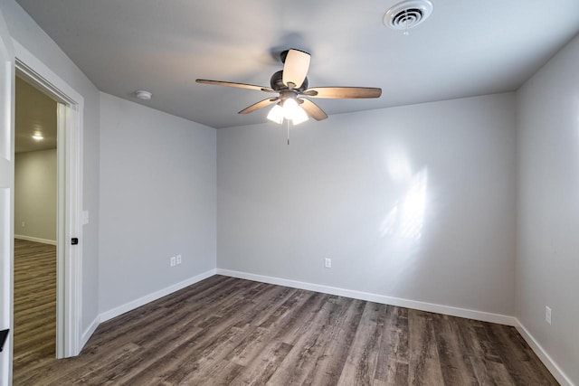 empty room with dark wood-type flooring and ceiling fan