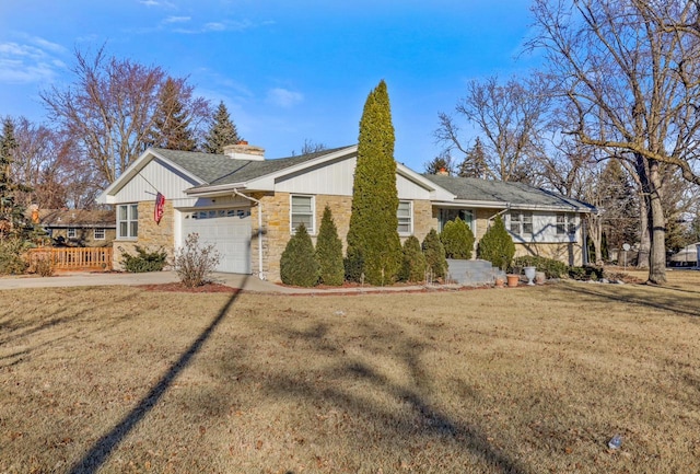 ranch-style house with a garage and a front lawn