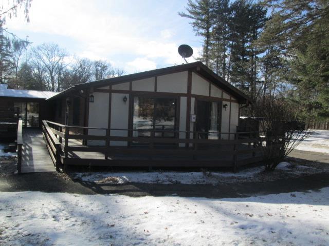 view of snow covered rear of property