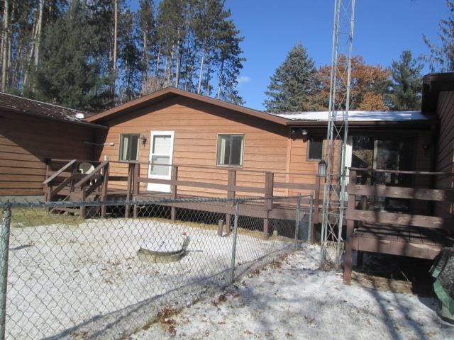 view of snowy exterior featuring a wooden deck