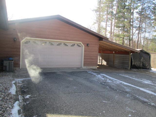 garage featuring central AC and a carport