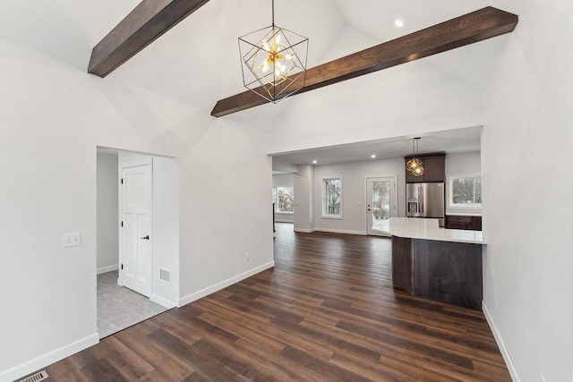 unfurnished living room with dark hardwood / wood-style floors and high vaulted ceiling