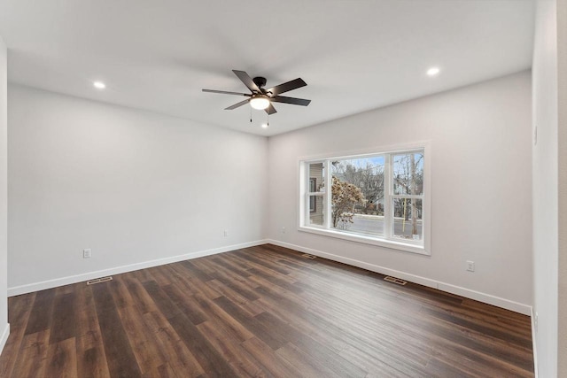 spare room with ceiling fan and dark wood-type flooring