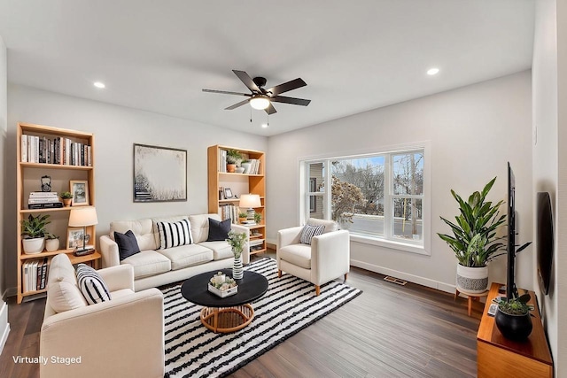 living room featuring dark hardwood / wood-style floors and ceiling fan