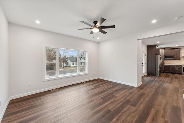 unfurnished living room with ceiling fan and dark hardwood / wood-style floors