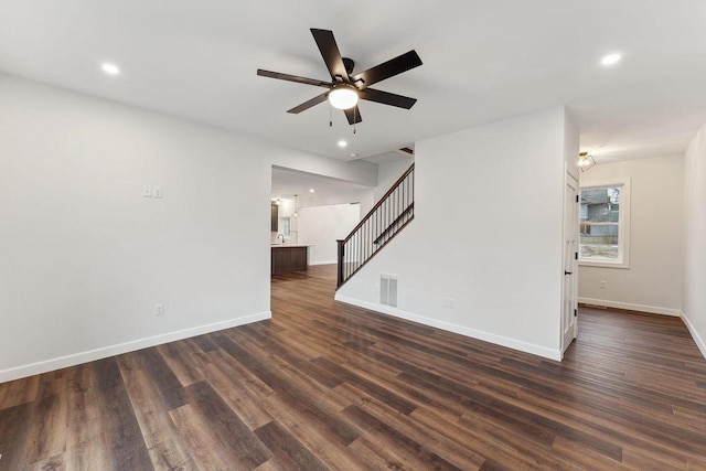 unfurnished living room with ceiling fan and dark hardwood / wood-style flooring