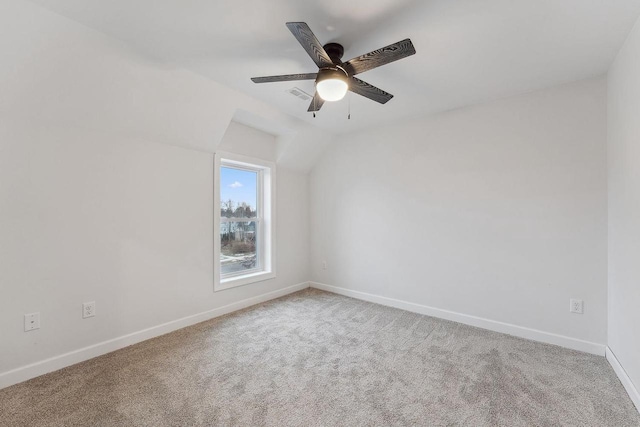 carpeted empty room with ceiling fan and lofted ceiling