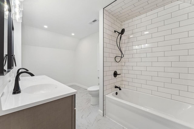 full bathroom featuring toilet, vanity, and tiled shower / bath