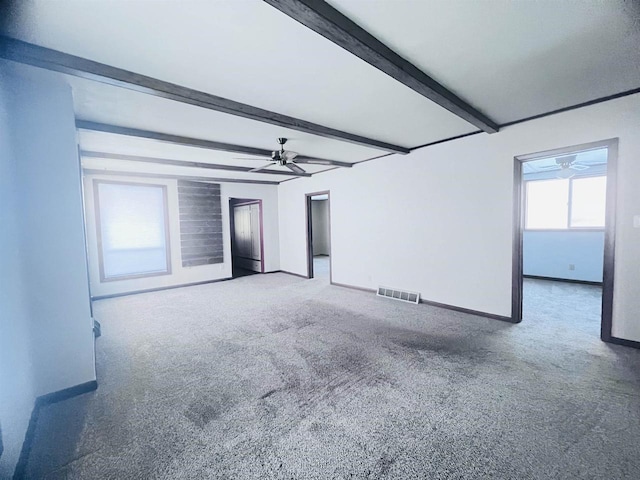 unfurnished room featuring ceiling fan, beam ceiling, and carpet flooring