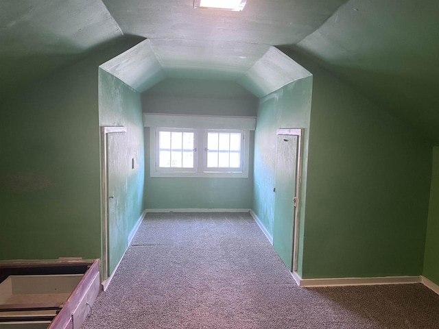 bonus room with carpet floors and vaulted ceiling