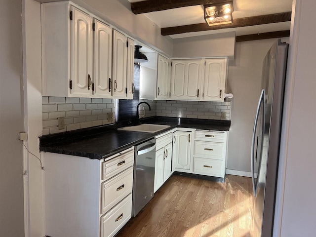 kitchen with light hardwood / wood-style flooring, appliances with stainless steel finishes, sink, tasteful backsplash, and white cabinetry