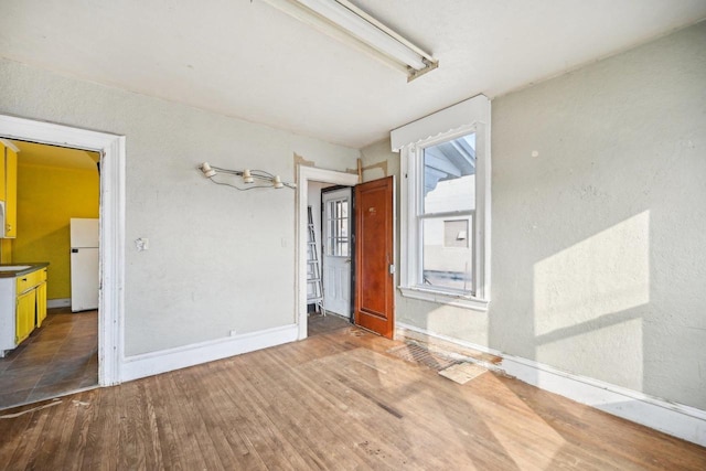 spare room with dark hardwood / wood-style floors