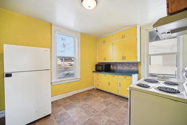 kitchen with white appliances and extractor fan