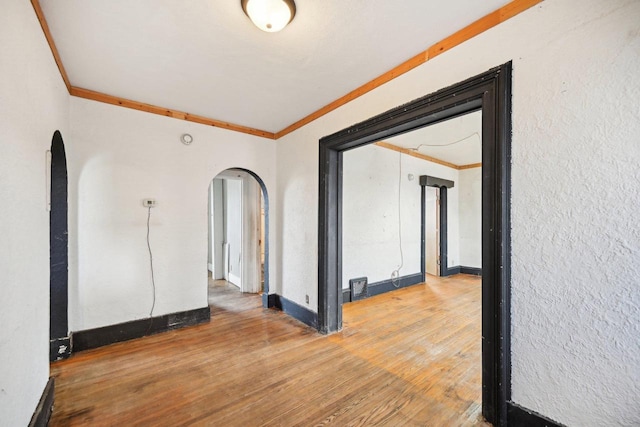 spare room with hardwood / wood-style flooring and ornamental molding