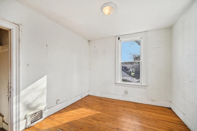 unfurnished room featuring hardwood / wood-style floors