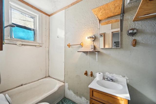 bathroom featuring a washtub and vanity