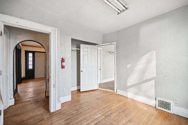 unfurnished bedroom featuring a closet and wood-type flooring