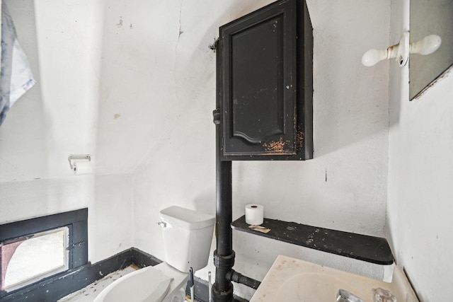 bathroom with toilet and lofted ceiling