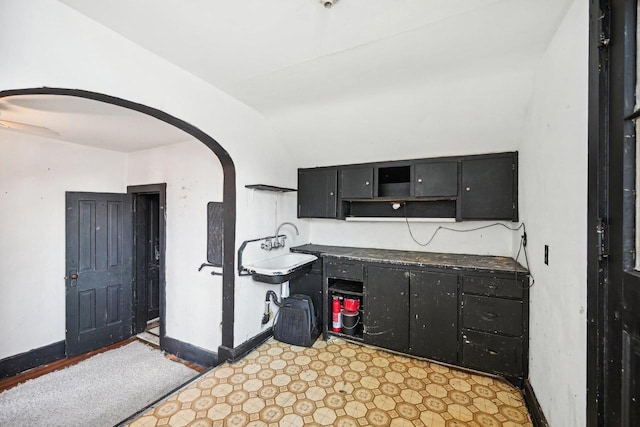 kitchen with sink and vaulted ceiling