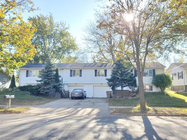 view of front of house with a garage and a front yard