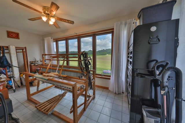 tiled dining area with ceiling fan