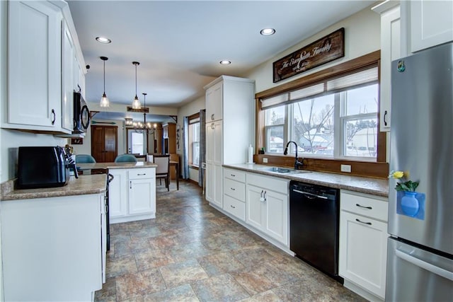 kitchen featuring black dishwasher, stainless steel refrigerator, hanging light fixtures, white cabinets, and kitchen peninsula