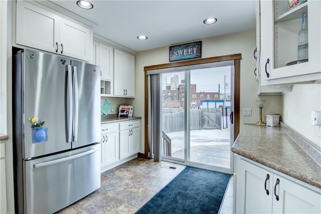 kitchen featuring white cabinets and stainless steel fridge