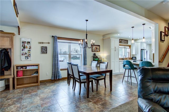 dining area featuring a notable chandelier