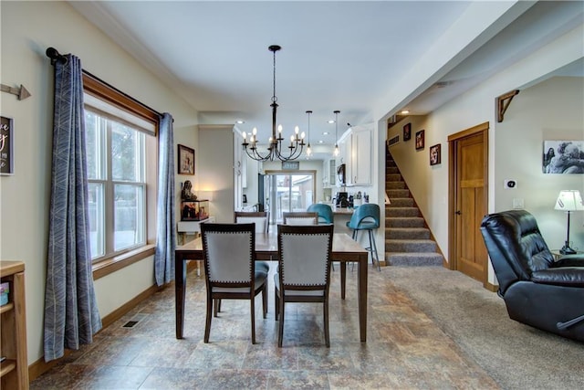 dining space featuring a notable chandelier