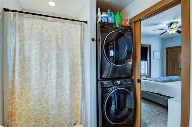 laundry room with ceiling fan, stacked washing maching and dryer, and carpet flooring