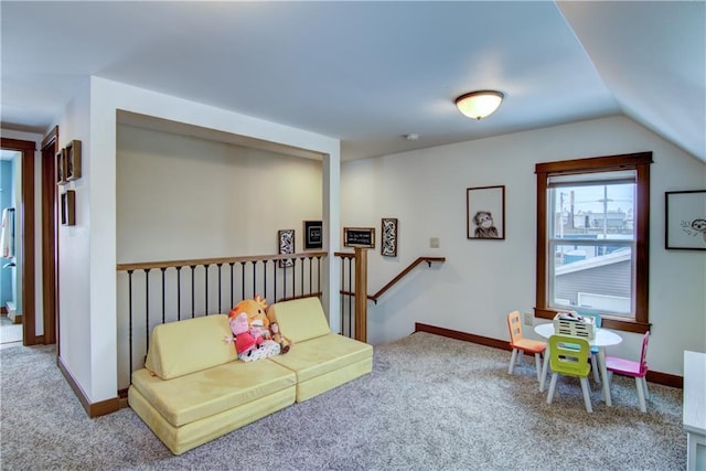 interior space featuring carpet floors and vaulted ceiling