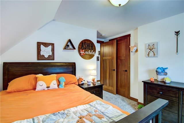 bedroom with vaulted ceiling and carpet flooring