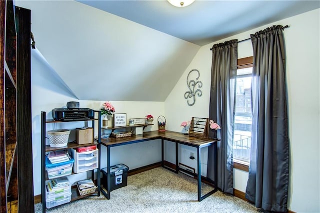 carpeted office with lofted ceiling