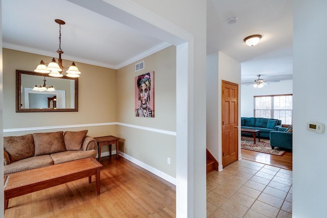 tiled living room with crown molding and ceiling fan with notable chandelier